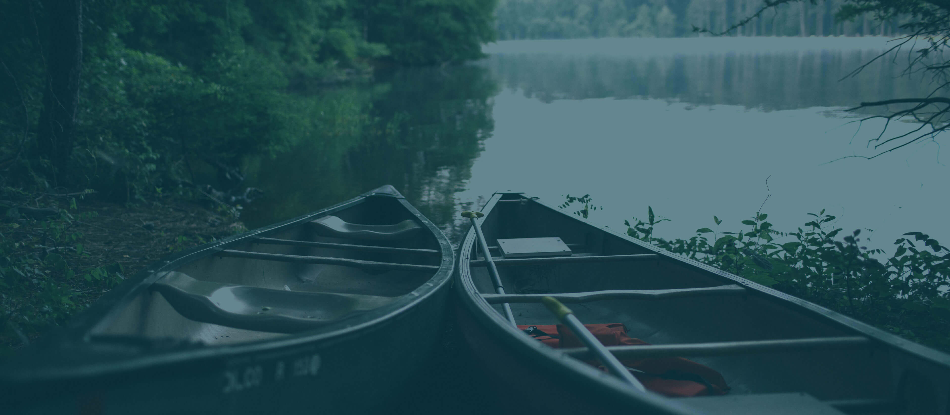 Two canoes by a lake