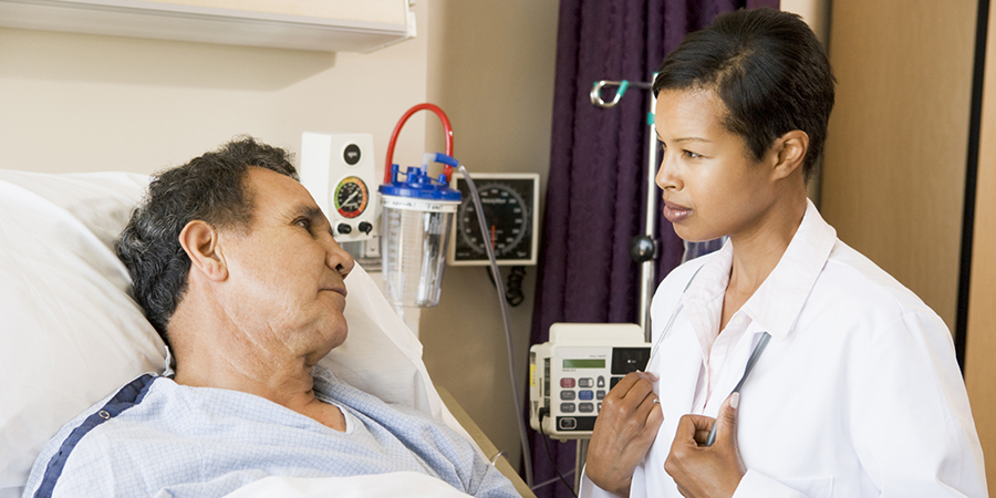 a patient in a hospital bed communicates with a provider