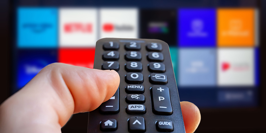 Person using a remote to watch tv