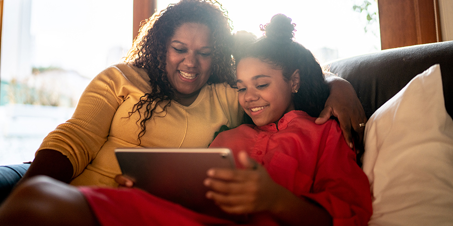 Mother and daughter looking at a tablet