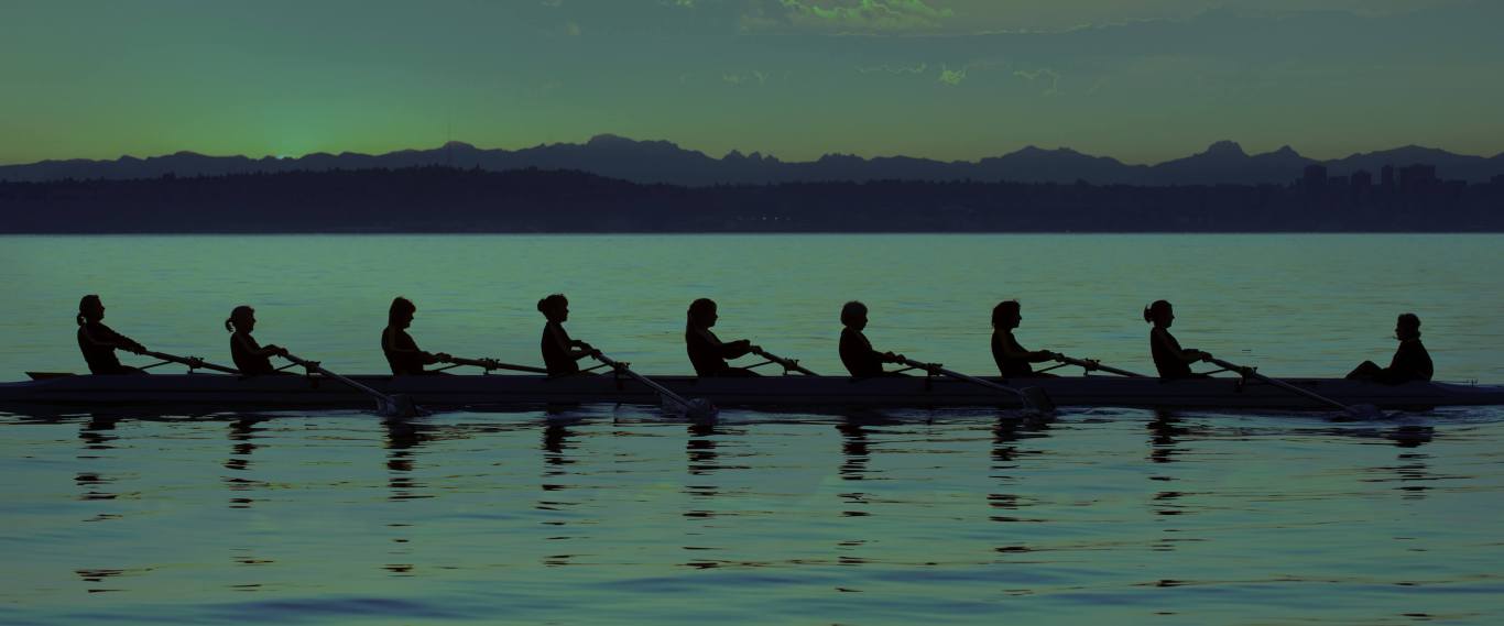 People rowing boat on lake